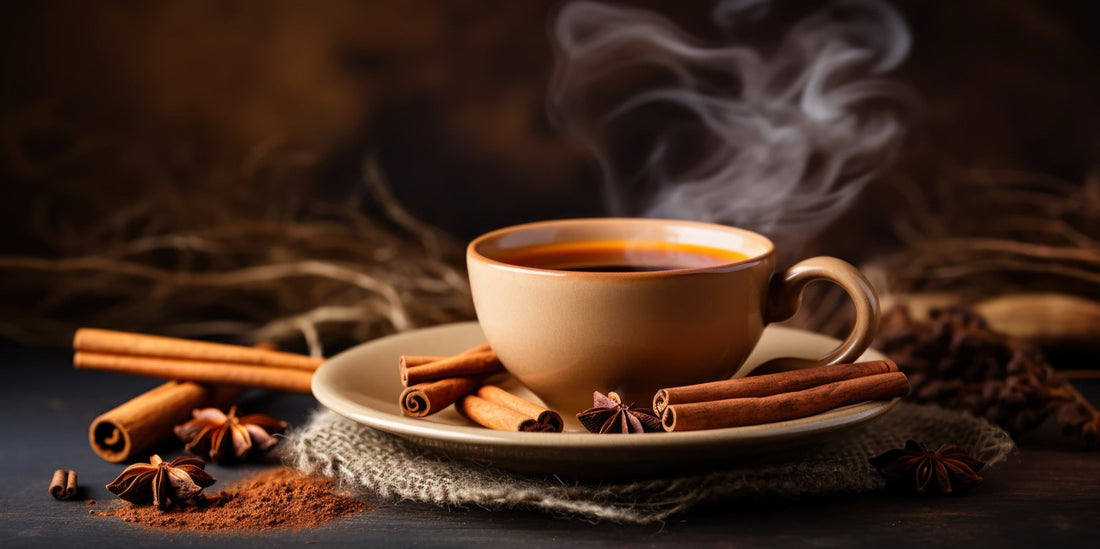 A cozy cup of cinnamon tea with whole cinnamon sticks and ground powder beside it — the warm sweet kind of cinnamon proper Ceylon delivers