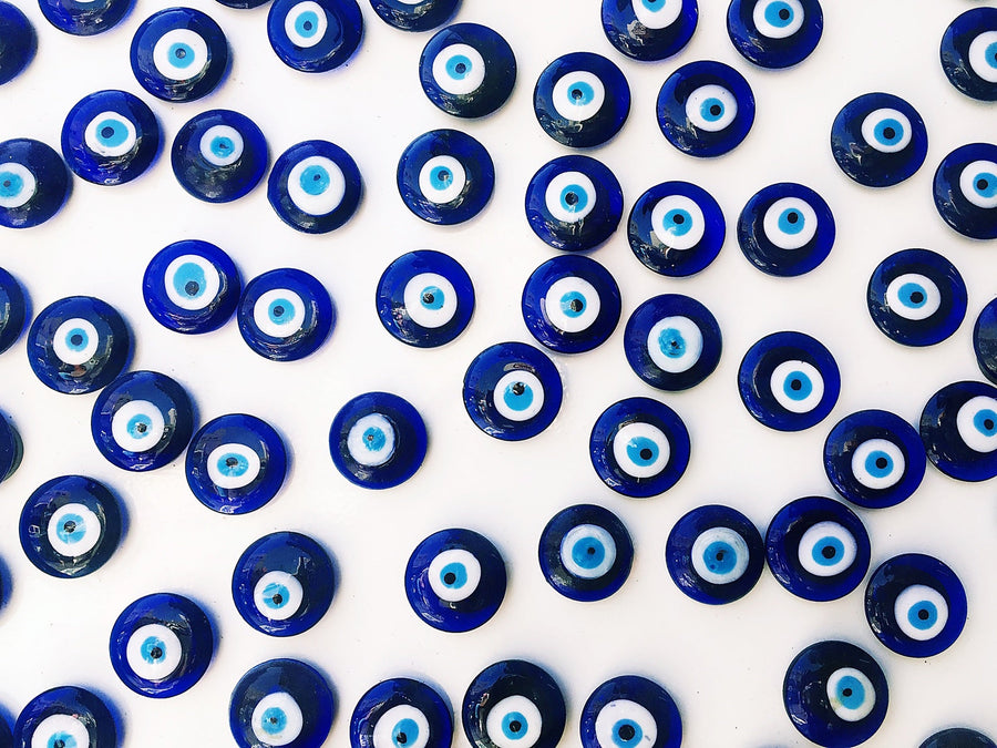 Traditional blue glass nazar beads — the evil-eye amulet that travels across South Asian, Mediterranean and Levantine craft traditions