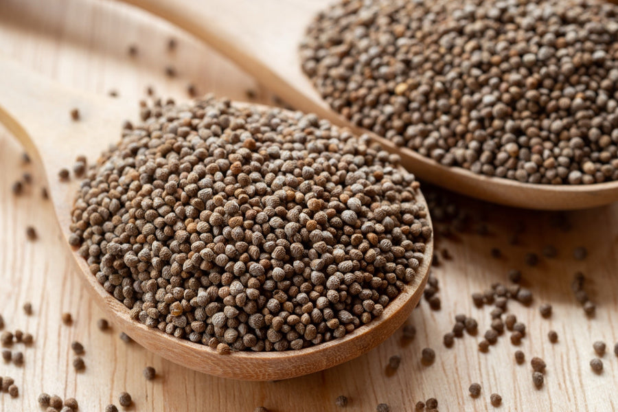 Close-up of perilla seeds in a wooden spoon — nei lieh, the Khasi name for the seed used in traditional Meghalaya chutneys