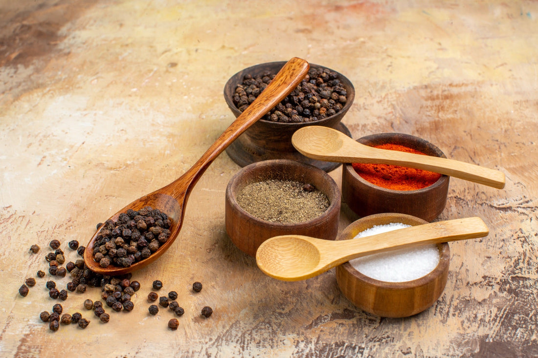 Single-origin spices in small wooden bowls — the kind sourced from named family farms