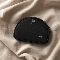 Ginza Tech Pouch in Black resting on natural oatmeal linen