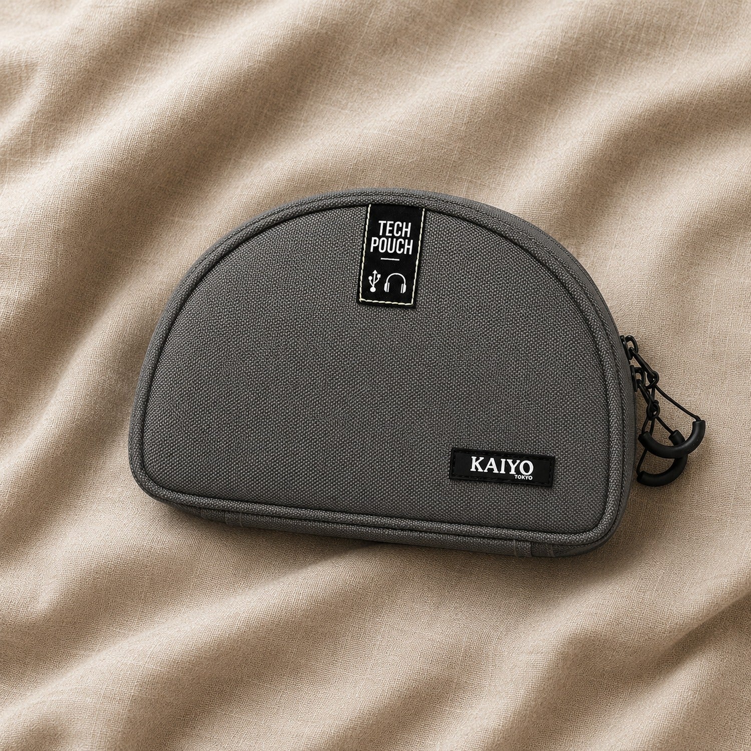 Ginza Tech Pouch in Fossil Grey resting on natural oatmeal linen