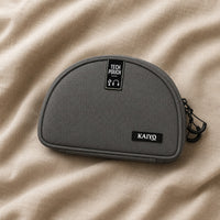Ginza Tech Pouch in Fossil Grey resting on natural oatmeal linen