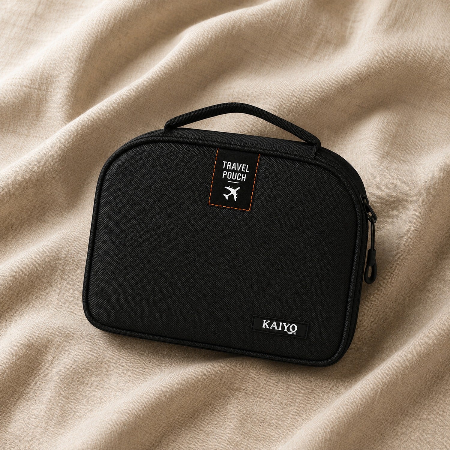 Ginza Travel Pouch resting on natural oatmeal linen
